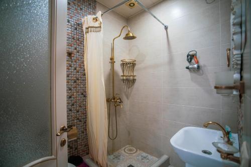 a bathroom with a shower and a sink at Borjomi Classic Hotel in Borjomi