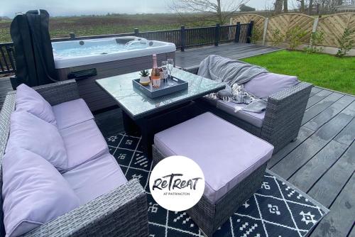 a deck with a table and chairs and a hot tub at ReTreat Breaks - 45 Park Lane in Patrington