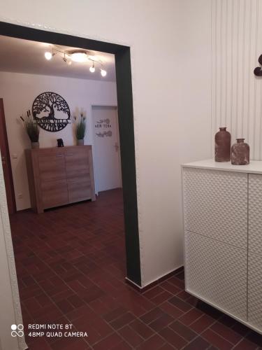 a hallway with a mirror and a dresser in a room at Park Villa Ferienwohnung mit Pool und 3 Schlafzimmer in Uelzen
