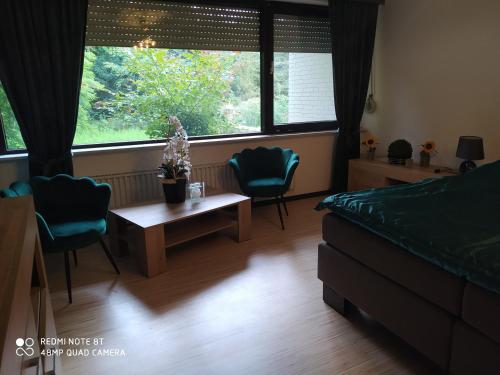 a bedroom with a bed and a table and chairs at Park Villa Ferienwohnung mit Pool und 3 Schlafzimmer in Uelzen