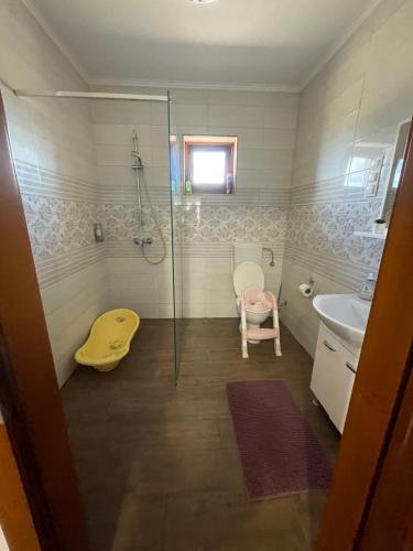 a bathroom with a glass shower and a sink at Kovács tanya - falusi szálláshely in Kunmadaras