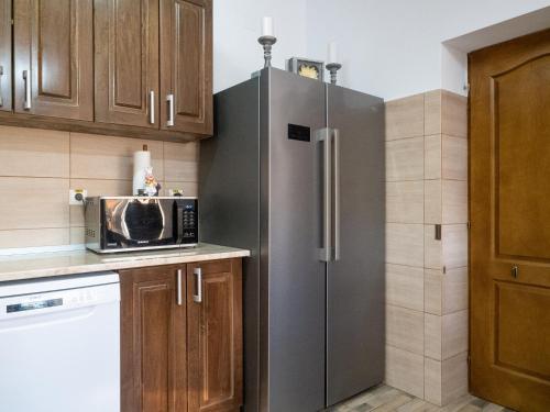 a kitchen with a refrigerator and a microwave at Laguna Nuferilor Habitat in Somova