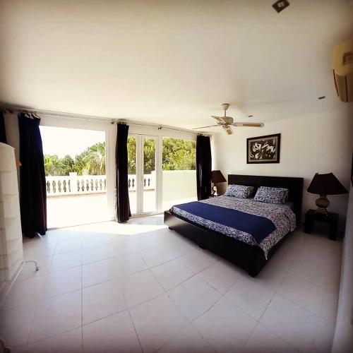 a bedroom with a bed and a large window at Casa Hokie in Colonia de Sant Pere