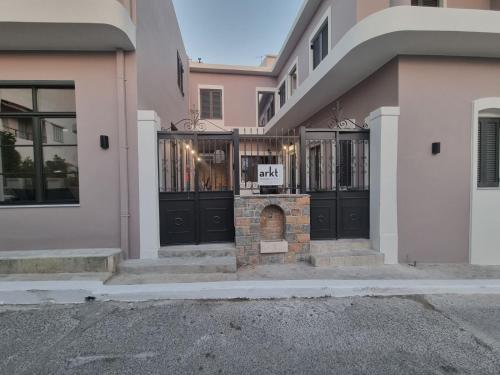 a house with a gate with a sign on it at MOD 15 City Centre in Agios Nikolaos