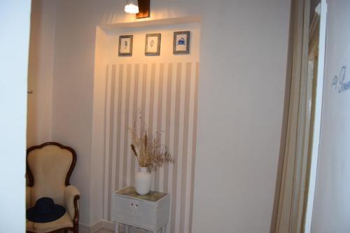 a hallway with a curtain and a chair and a table at Levante - Meridiana case al mare in Mattinata