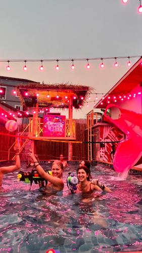a group of children swimming in a swimming pool at Slumber Party Krabi in Ao Nang Beach