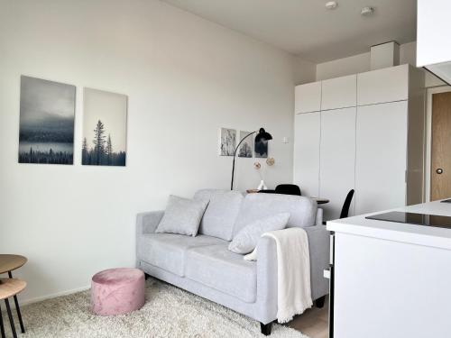 a living room with a couch and a table at Modern Penthouse Studio with Private Terrace in Rovaniemi