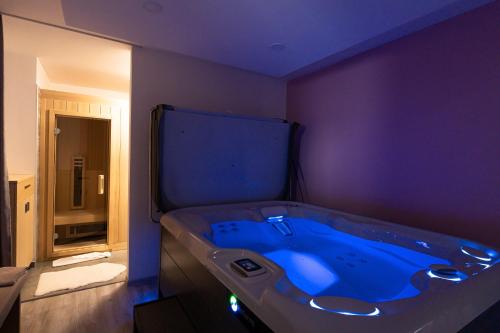 a bathroom with a blue tub in a room at Grajski Dvor in Radovljica