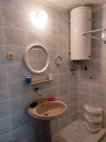 a bathroom with a sink and a mirror at Apartman Milicevic in Boreti