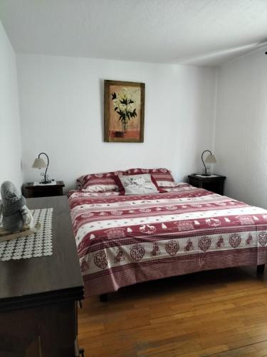 a bedroom with a bed with a table and two lamps at Casa Vauterin in La Thuile