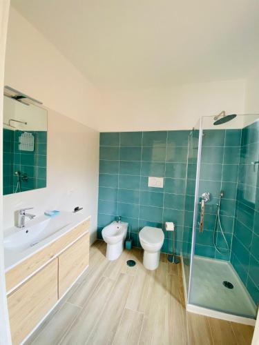 a bathroom with a toilet and a sink and a shower at Guest House Tramontana 19 in Porto Ercole