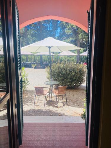 an open door with a table and an umbrella at Villa Gaia in Portoferraio