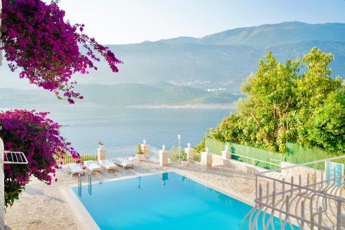 a swimming pool with a view of the water at Club Çapa Hotel in Kas