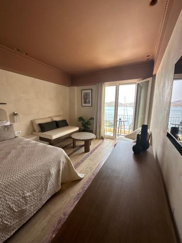 a bedroom with a bed and a view of the ocean at Igisó in Ermoupoli