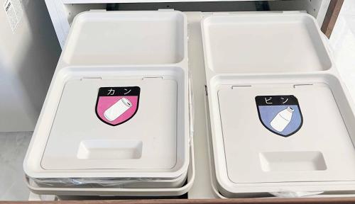 two white plastic containers sitting in a refrigerator at Rainbow Village（レインボーヴィレッジ） in Mihama