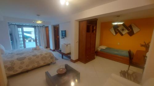 a view of a bedroom with a bed and a mirror at 3 Palmeiras Guest Lounge in Miguel Pereira
