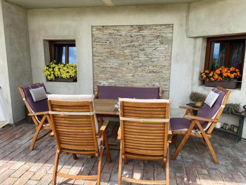 a wooden table and chairs on a patio at Statek na samotě in České Meziříčí