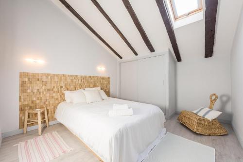 a white bedroom with a white bed and a window at Bohemian 2bedroom attic in Lavapies in Madrid