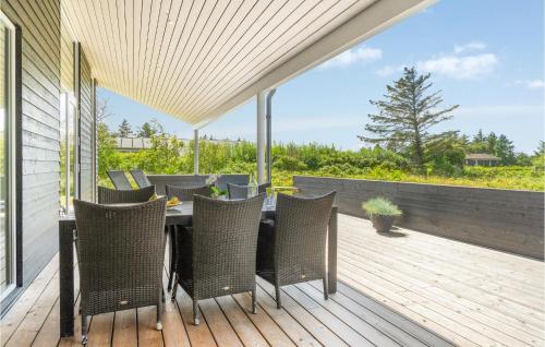 a patio with a table and chairs on a deck at Holiday Home Karensvej in Grønhøj