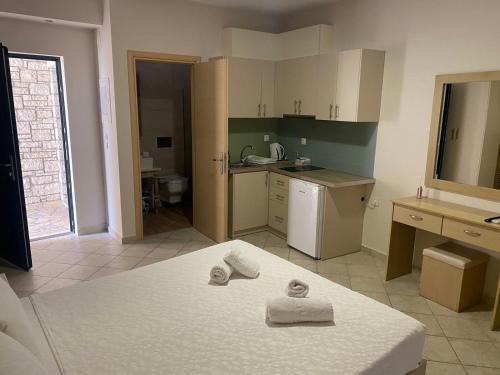 a kitchen with two towels on top of a bed at Sivota Muses in Syvota