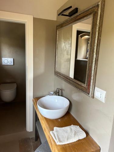a bathroom with a bowl sink and a mirror at matana b&b in Carmignano