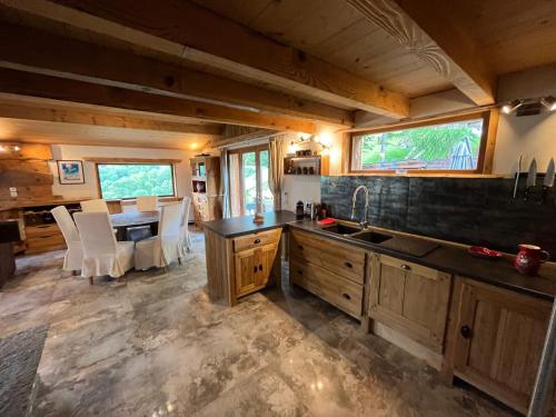 a kitchen and dining room of a tiny house at CHALET TOUDBIOLE haut de chalet in Les Houches