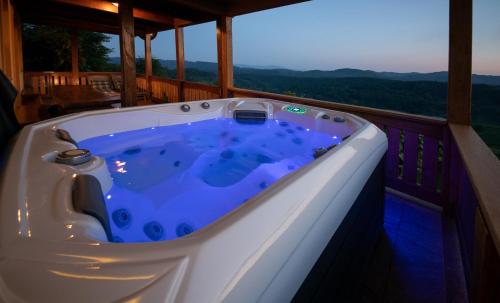 a jacuzzi tub on the deck of a house at Holiday Home Mirt with HotTub & Sauna in Blanca