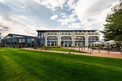 a large building with a lawn in front of it at Kings' Valley Medical & Spa Hotel in Kazanlŭk