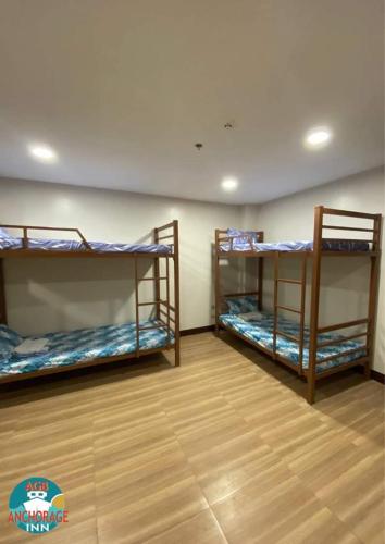 מיטה או מיטות קומותיים בחדר ב-AGB Anchorage Inn, male dorm