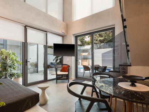 a living room with a table and chairs at Grand Residences in Chania