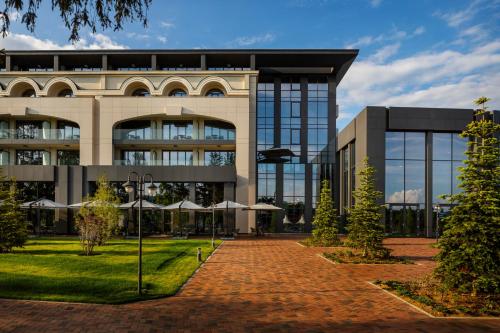 a building with a brick walkway in front of it at Kings' Valley Medical & Spa Hotel in Kazanlŭk