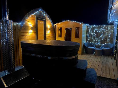 a barrel sitting on a deck with christmas lights at Thompson Hall Retreat in Thompson