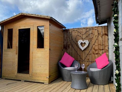 a deck with two chairs and a dog house at Thompson Hall Retreat in Thompson