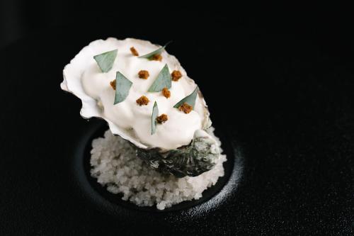 a dessert with white frosting on a pile of rice at Domaine du Limonay, The Originals Collection in Saint-Méloir-des-Ondes