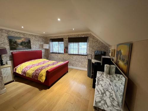 a bedroom with a bed and a desk in it at The Caduceus- Residence in Chertsey