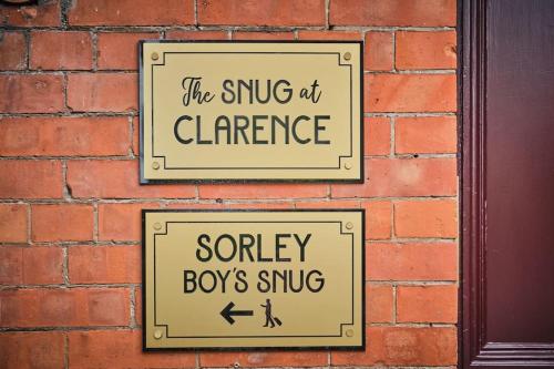 two signs on a brick wall that say the subway atchange soley boys sing at The Snug @ Clarence in Derry Londonderry
