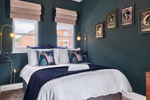 sypialnia z łóżkiem z niebieskimi ścianami i oknem w obiekcie The Snug @ Clarence w mieście Londonderry/Derry