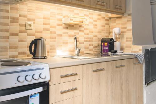a kitchen with a sink and a stove top oven at Notus Vacation House in Lefkímmi