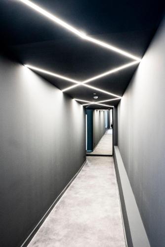 a hallway with black walls and white lights at Coliving Compostela in Santiago de Compostela