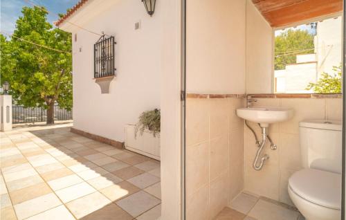 a bathroom with a toilet and a sink at Beautiful Home In Iznate With Outdoor Swimming Pool in Iznate