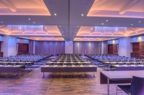 a large room with rows of tables and chairs at IMLAUER HOTEL PITTER Salzburg in Salzburg