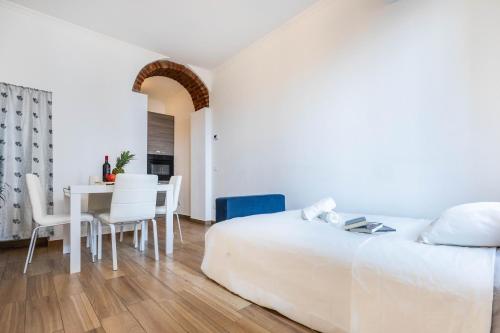a bedroom with a bed and a table and chairs at Divi Apartments Milano - Strategic Place in Milan