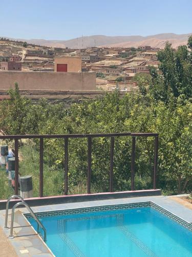 a swimming pool with a view of a city at Riad Bouchra in Tamtetoucht