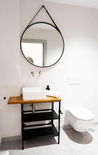 a bathroom with a mirror on the wall at Coliving Compostela in Santiago de Compostela