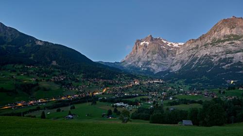 a town in a valley between two mountains at Aspen Alpine Lifestyle Hotel in Grindelwald