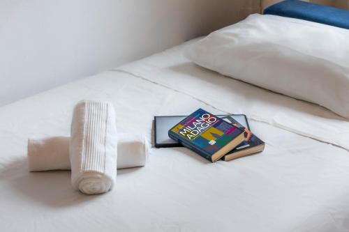a book sitting on top of a bed at Divi Apartments Milano - Strategic Place in Milan