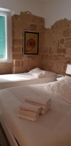 アルゲーロにあるAligaのタオル付きのドミトリールームのベッド2台