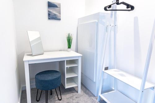 a white desk with a laptop on it next to a shower at Stylish & Contemporary 2-Bedroom House in Worksop