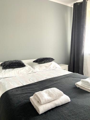 a bedroom with two beds with white towels on them at Z MIŁOŚCI DO GÓR Noclegi in Piechowice