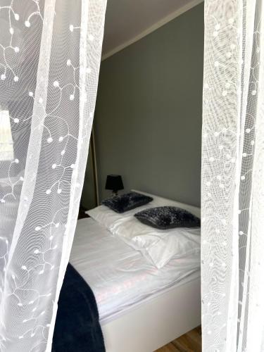 a bedroom with a bed with a canopy at Z MIŁOŚCI DO GÓR Noclegi in Piechowice